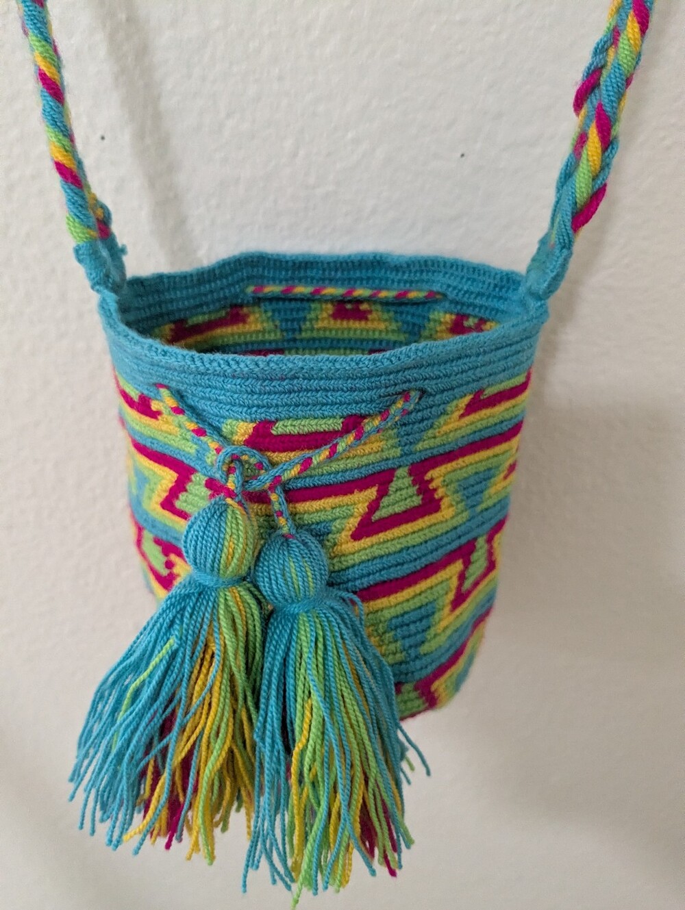 Crochet bucket bag, turquoise with pink and yellow, tassel strap.